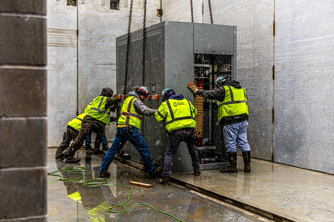 Muska field team positioning industrial electrical equipment