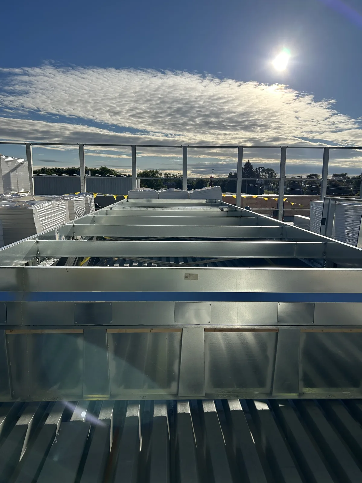 Fabricated metal rooftop curb with internal support framing.