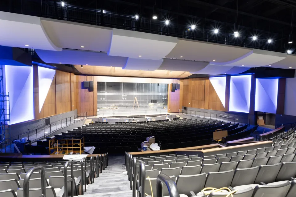 Lighting and ceiling installations above the stage and seating in the White Bear Lake High School auditorium.