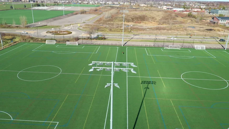 Aerial view of playing fields and light poles at the National Sports Center.