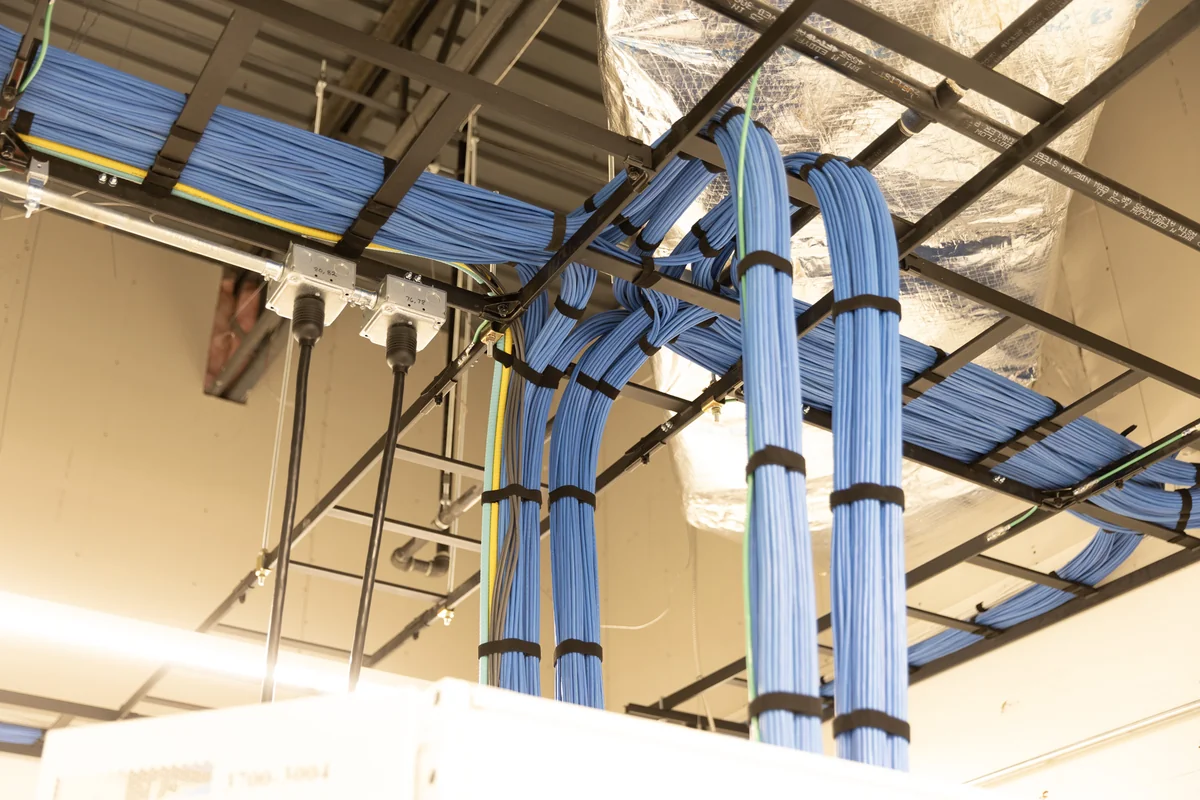 Blue low-voltage cable bundles routed through overhead supports at CenterPoint.